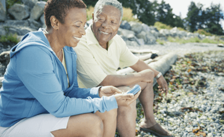 Older couple sitting togther on rocks