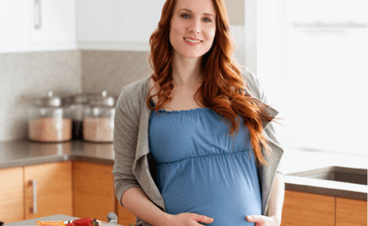Woman holding pregnant belly