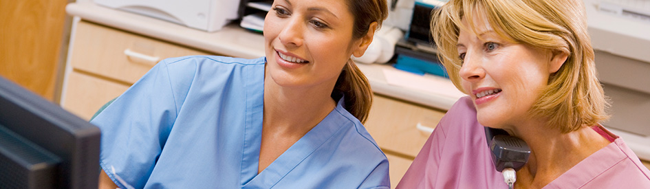 Nurses looking at a computer