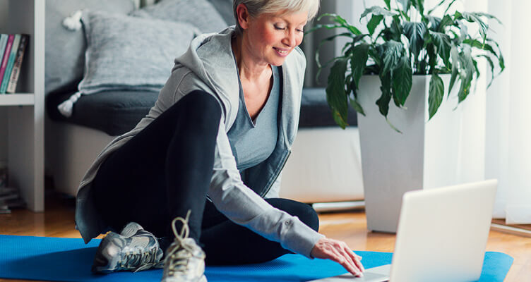 Person wearing gym clothes using laptop