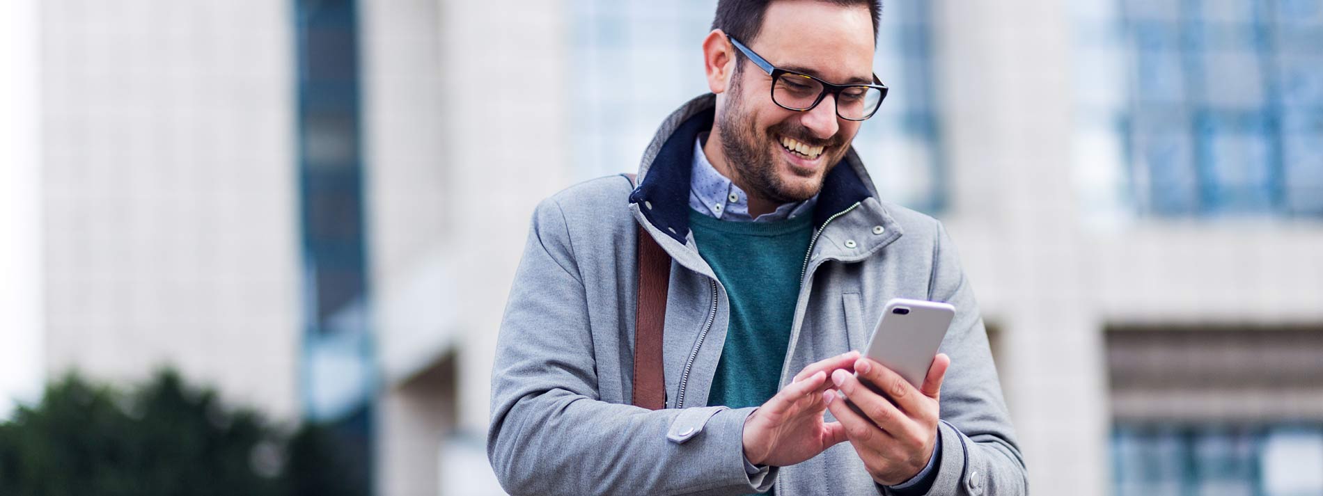 Businessman-smiling-while-using-phone