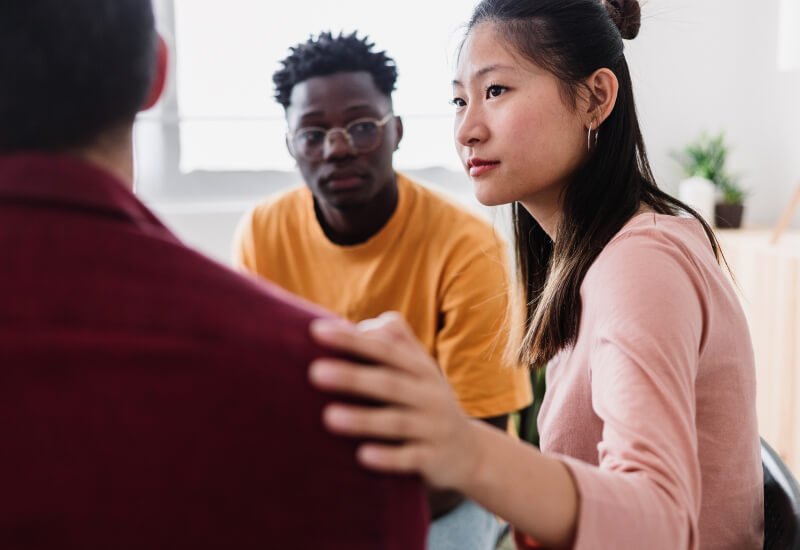 People sitting together in group therapy