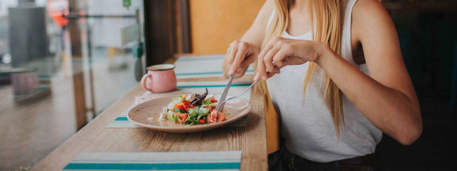 Woman-eating-salad-inside-restaurant