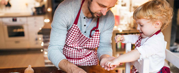 Father and son cooking together in kitchen