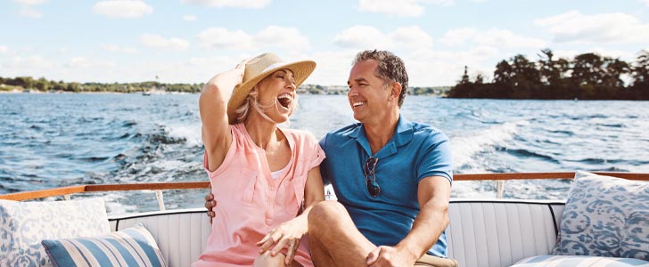 Man and woman smiling together on a boat