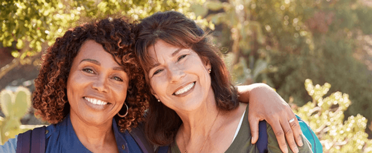 Two friends hugging outdoors