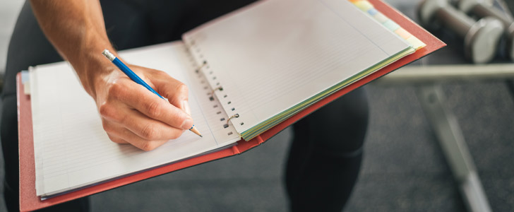 Close up of hand writing in a notebook