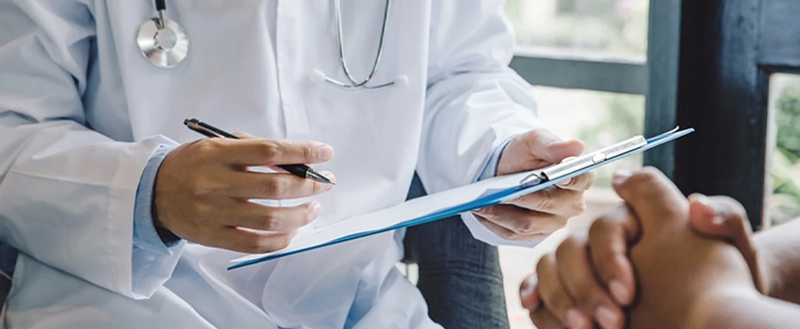 Doctor holding clipboard while checking off notes